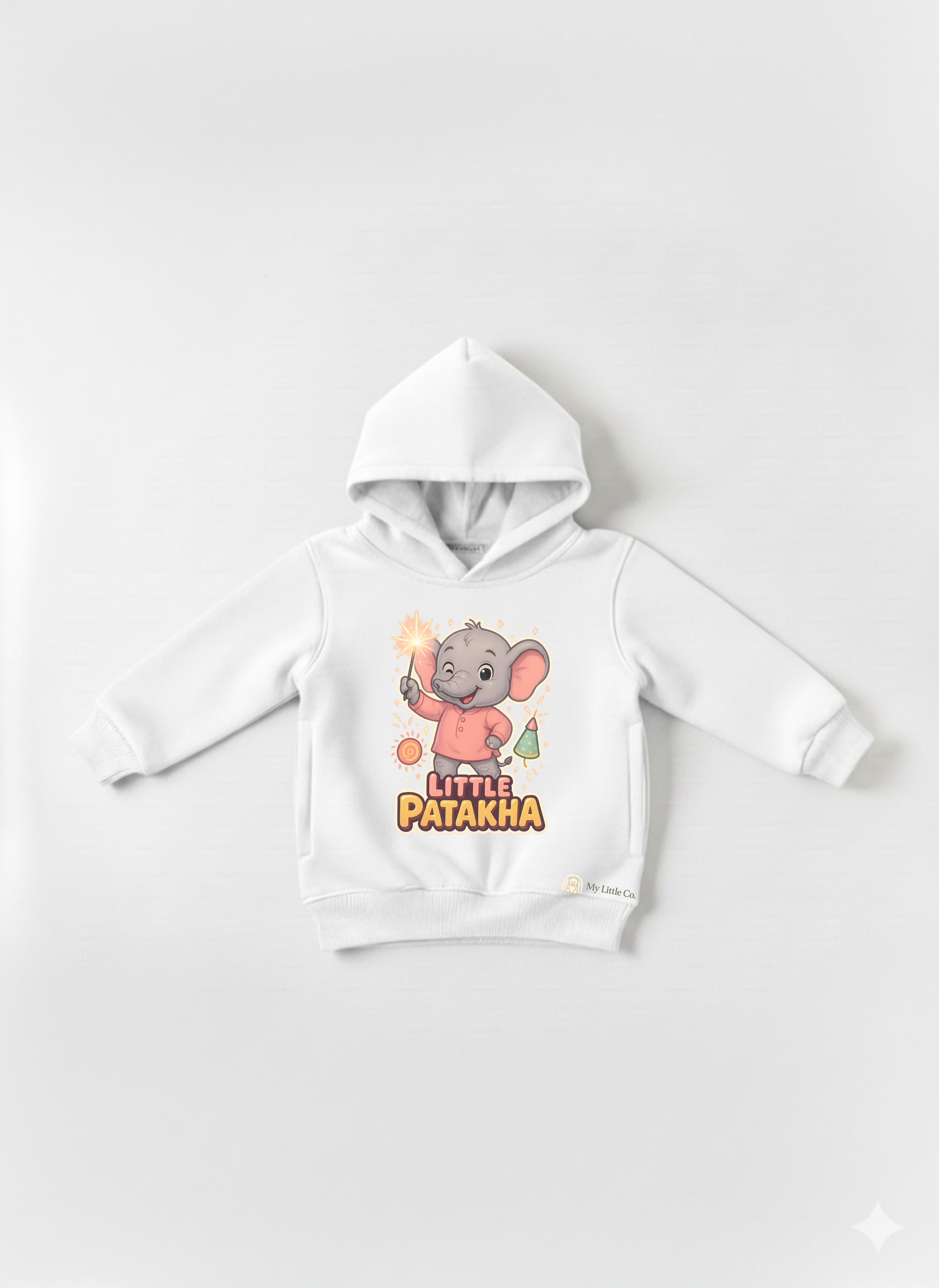 Close-up of witty "Little Patakha" slogan and sparkler elephant graphic on bright white fabric.