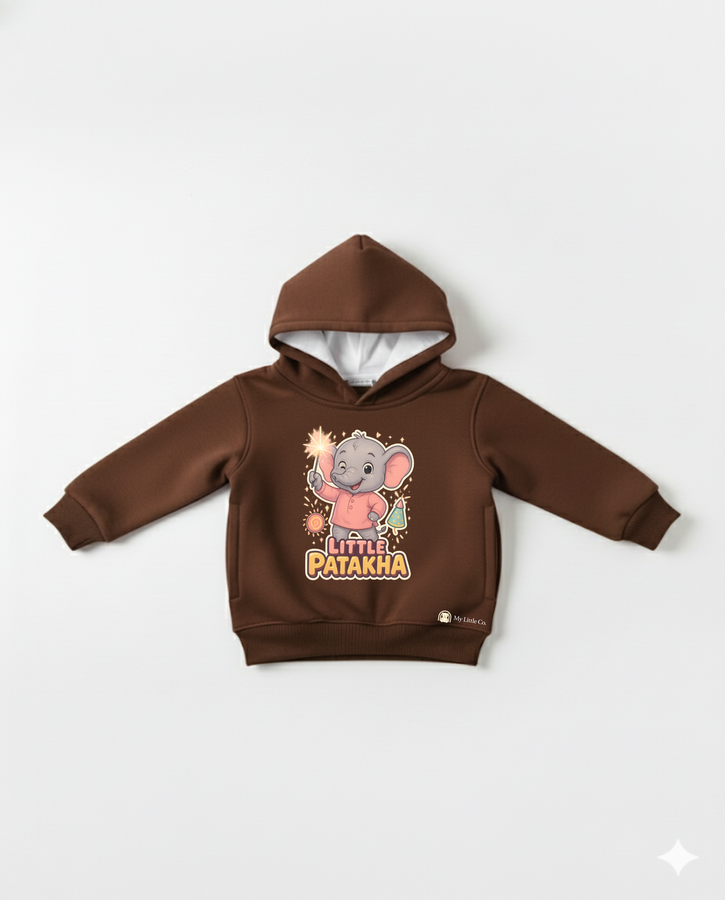Close-up of witty "Little Patakha" slogan and sparkler elephant graphic on rich brown fabric.