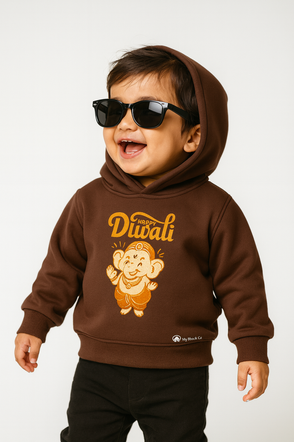 Cute toddler boy in coffee brown "My First Diwali" Ganesha print hoodie.