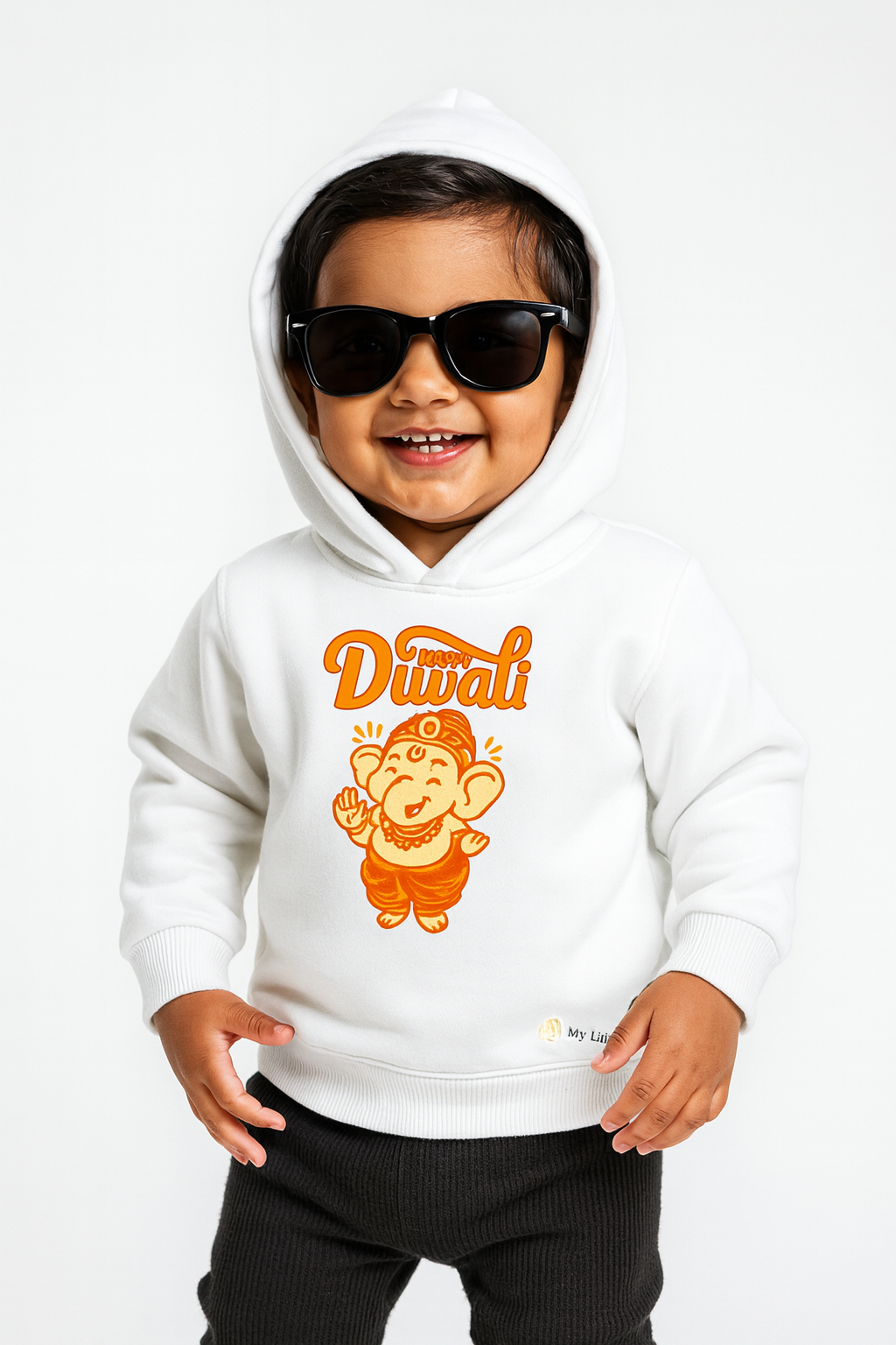 Cute toddler boy in white "My First Diwali" Ganesha print hoodie.
