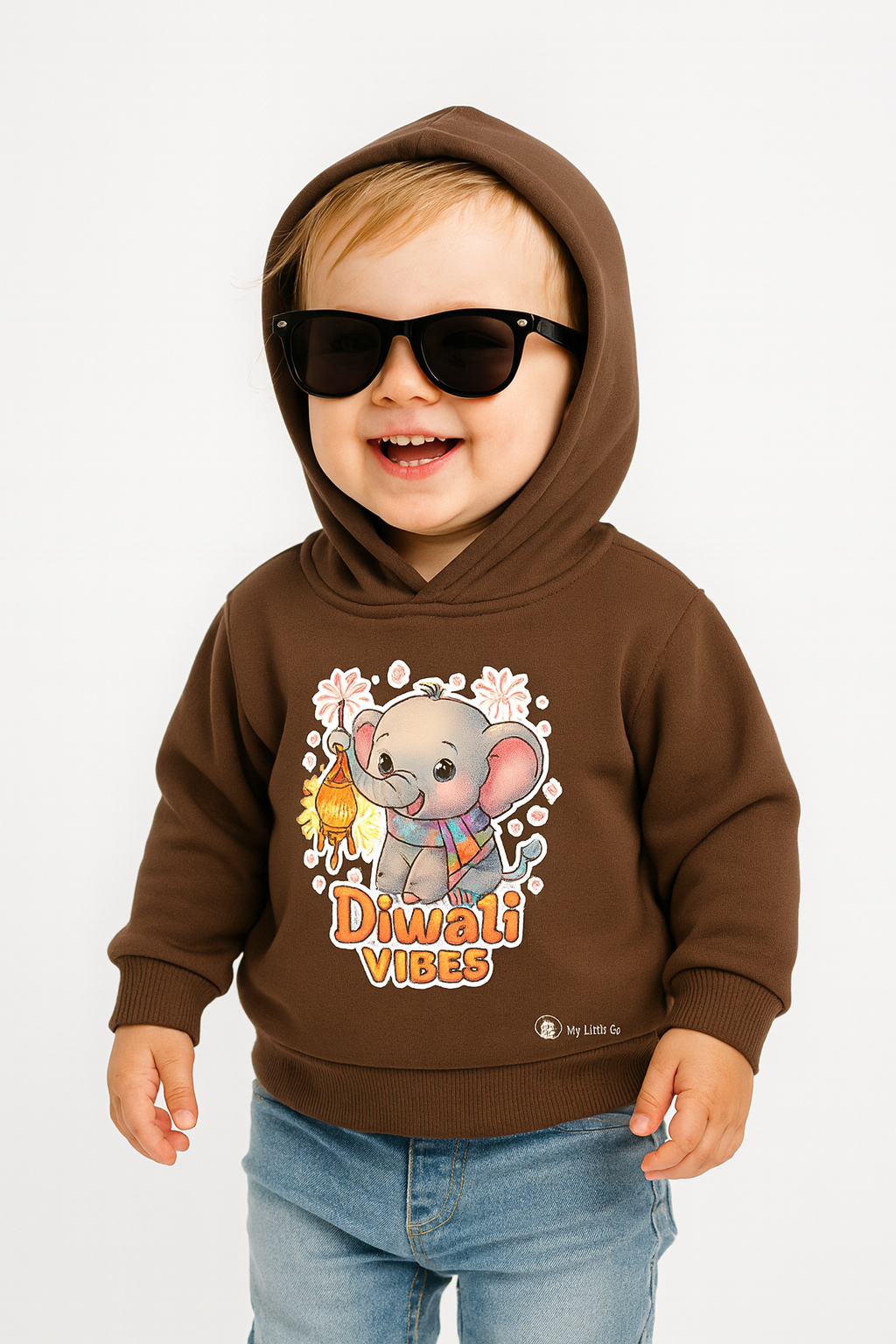 Happy toddler in coffee brown "Diwali Vibes" elephant print hoodie mockup for kids.