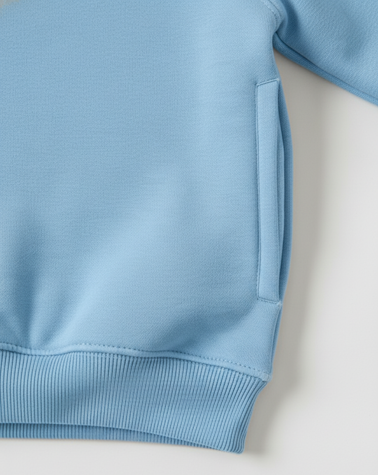 Close-up of a light blue sweatshirt on a white background