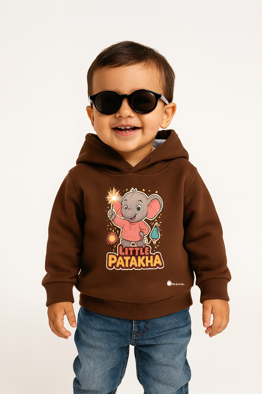 Smiling toddler wearing Little Patakha elephant print coffee brown hoodie and sunglasses. Diwali fun.