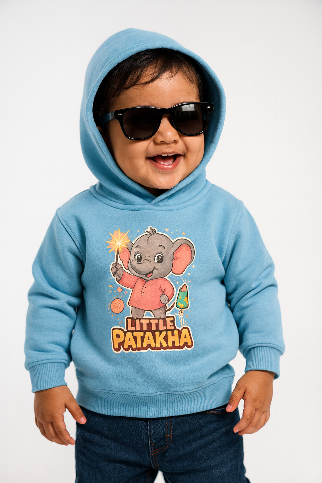 Smiling toddler wearing Little Patakha elephant print sky blue hoodie and sunglasses. Diwali fun.